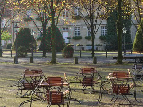 A row of chairs and tables in a park photo