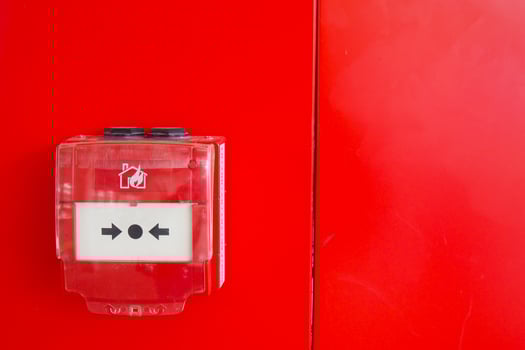 Red fire alarm button on wall , photo