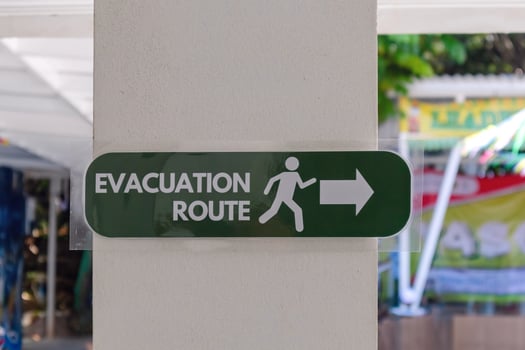 Evacuation route sign on a pillar in a school building photo