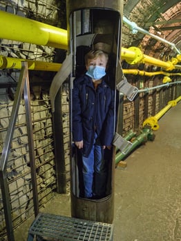 A child wearing a mask in a tunnel photo