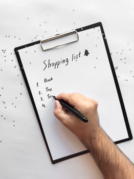 Creative shopping list on clipboard surrounded by silver stars photo