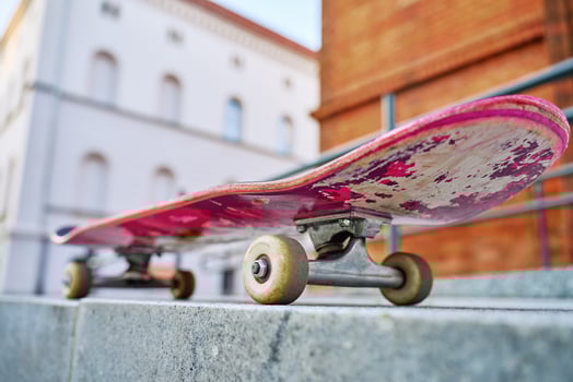 Close-Up of Worn Skateboard at city street photo