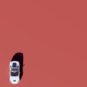 An overhead view of a white car on a red background photo