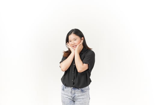 beautiful Asian woman gently holds her cheeks with both palms, showcasing a soft expression against a white background photo