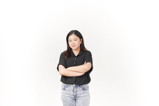 beautiful Asian woman stands with her arms folded across her chest, exuding confidence against a white background photo