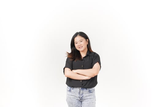 beautiful Asian woman stands with her arms folded across her chest, exuding confidence against a white background photo