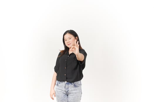 beautiful Asian woman smiles warmly while making an 'OK' hand gesture against a bright white background photo