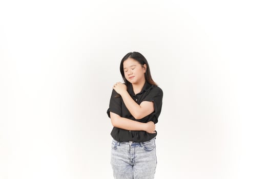 beautiful Asian woman places her hand gently on her chest, expressing sincerity or gratitude, against a white background photo
