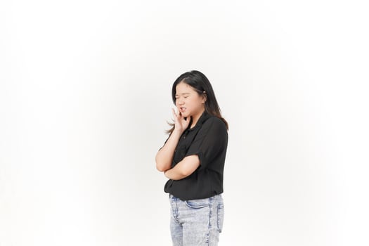 beautiful Asian woman poses with a pained expression, holding her cheek in discomfort due to a toothache against a white background photo