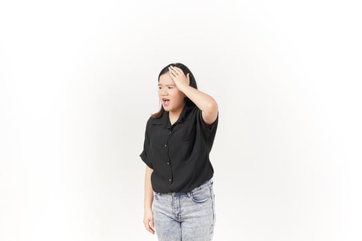 beautiful Asian woman holds her head in pain, with a pained expression showing signs of a headache against a white background photo