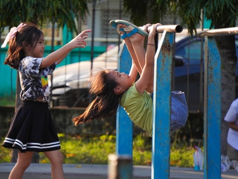 Sisters exercise outdoors in a park on exercise equipment during summer vacation. photo