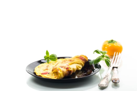 fried omelette with sweet pepper and vegetables in a plate, isolated on white background photo