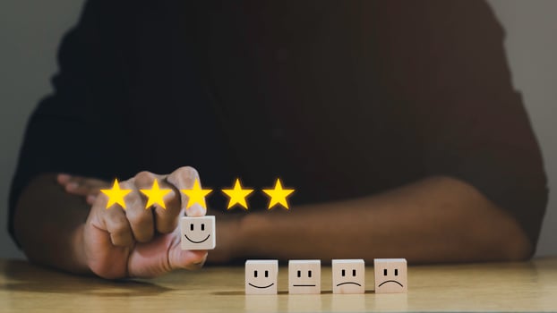 Customer services best excellent business rating experience. Satisfaction survey concept. Businessman chooses a happiest face on wood block. 5 Star Satisfaction. photo
