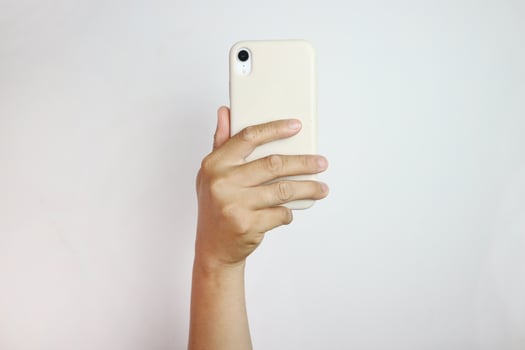 Person holding in hand mobile phone with triple lens camera, photo isolated on white background