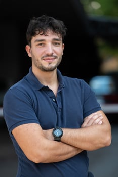 Portrait of a young successful entrepreneur in front of the company photo