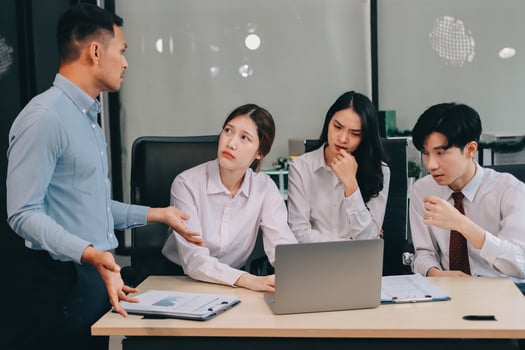 Frustrated upset multiracial business team people sad with bad work result in report disappointed in corporate bankruptcy failure crisis worried of paperwork problem sit at table at office meeting photo