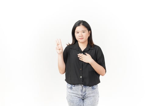 beautiful Asian woman stands confidently, holding her chest with one hand raised against a white background photo