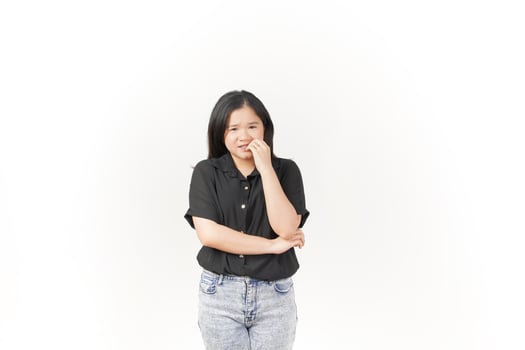 beautiful Asian woman looks scared, worried, and nervous, her expression full of anxiety against a white background photo