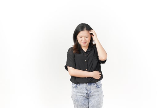 beautiful Asian woman holds her head in a headache pose, expressing discomfort against a white background photo