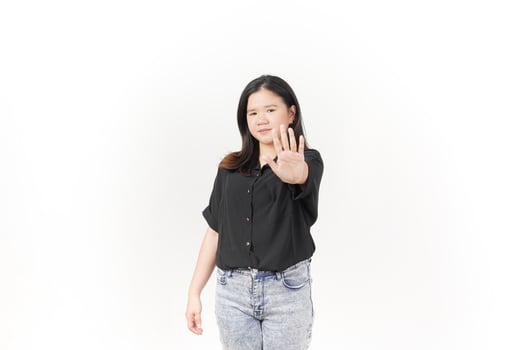 beautiful Asian woman poses with her hands raised in a 'no' gesture against a clean white background photo