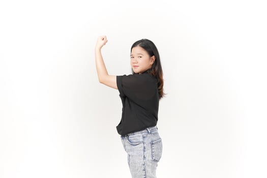 beautiful Asian woman strikes a bodybuilding pose, raising her arms confidently against a white background photo