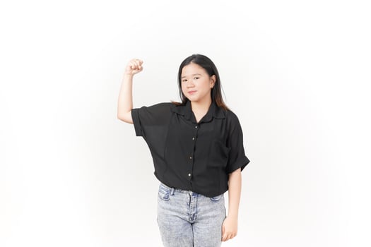 beautiful Asian woman strikes a bodybuilding pose, raising her arms confidently against a white background photo