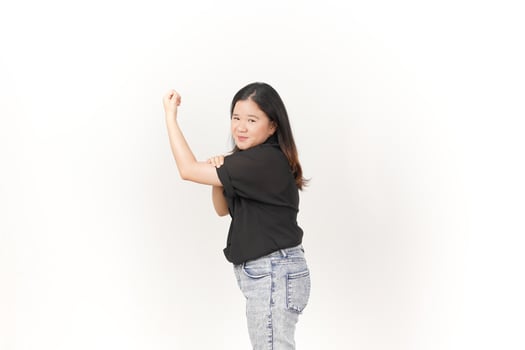 beautiful Asian woman strikes a bodybuilding pose, raising her arms confidently against a white background photo