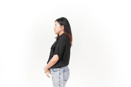 beautiful Asian woman stands in a thoughtful pose, lost in contemplation against a white background photo