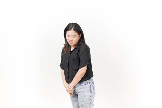beautiful Asian woman stands gracefully, looking down thoughtfully against a clean white background photo
