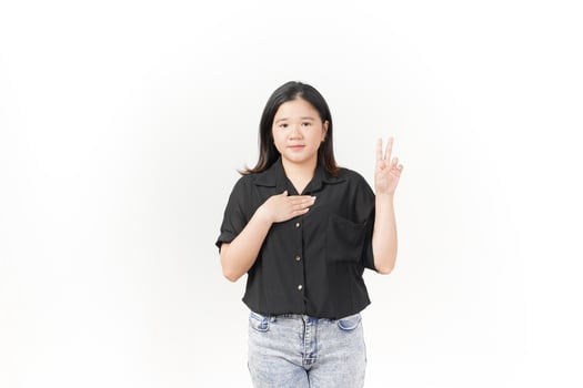 beautiful Asian woman stands confidently, holding her chest with one hand raised against a white background photo