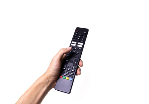 Hand holding television remote control isolated on white background. After edits. photo