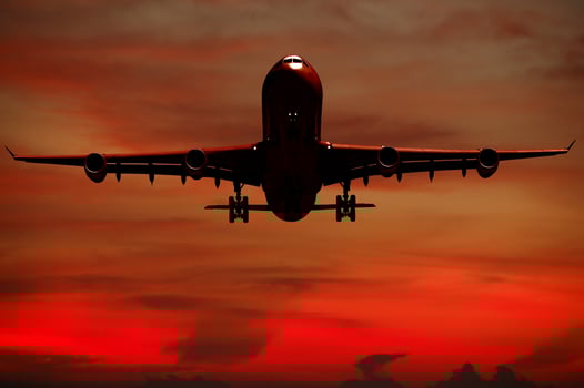 Air travel - Silhouett of plane and sunset photo