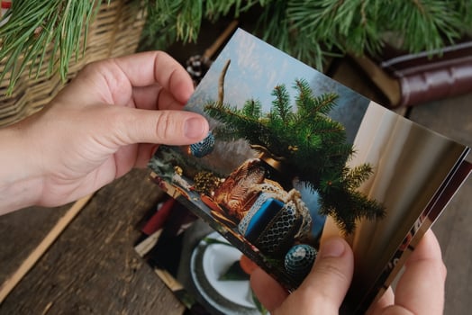 Woman looking at printed winter and Christmas photos