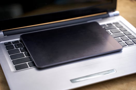 Digital workspace. closed laptop with tablet on keyboard for modern technology and efficient office setup. photo
