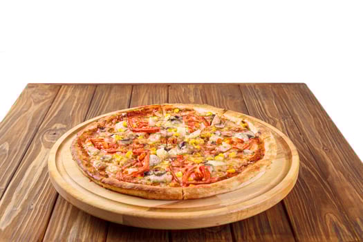 delicious pizza with chicken, mushrooms, cheese, tomatoes and corn on a wooden background photo
