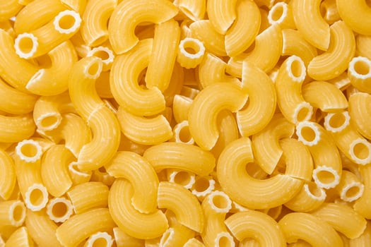 Uncooked Chifferi Rigati Pasta. A Culinary Canvas of Chifferi Rigati, Creating a Lively and Textured Background for Gourmet Cooking. Dry Pasta. Raw Macaroni - Top View, Flat Lay photo