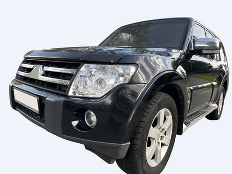 Black SUV car, close-up view. Large 4 4 automobile with headlights and bumper, ideal for road and photo