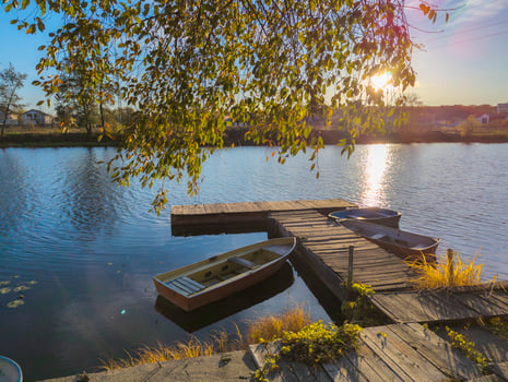 boats at the pier on the river in autumn sunset photo