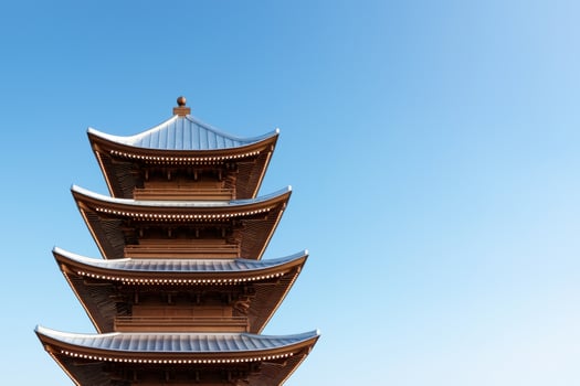 Ornate japanese pagoda against blue sky photo