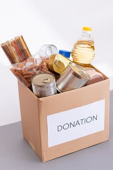 Donation Box of Free Food. Carton Box with Canned Food, Cereals and Grocery. Meal Reserves. Emergency Food Storage in Case of Crisis. Free Social Help, Blessings and Care. Strategic Food Supplies photo