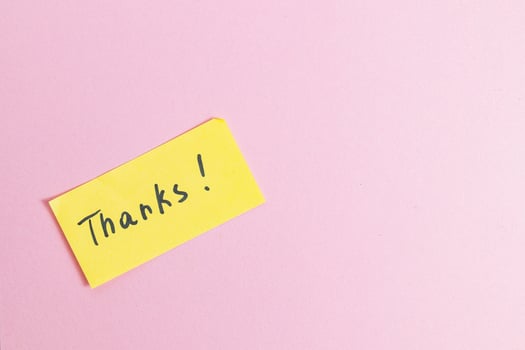 Yellow small note with the word thank you on a pink background in the center photo