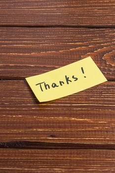 yellow sticky note with the word thanks written on it. photo