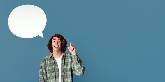 Funky young guy with speech bubble having creative idea on turquoise background, empty space for design photo