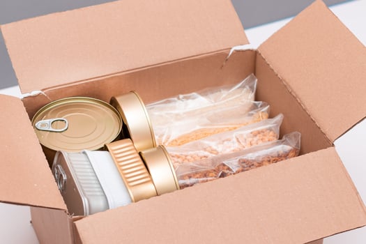 Food Reserves or Donation Box. Carton Box with Canned Food, Cereals and Grocery. Emergency Food Storage in Case of Crisis. Free Social Help, Blessings and Care. Strategic Food Supplies photo