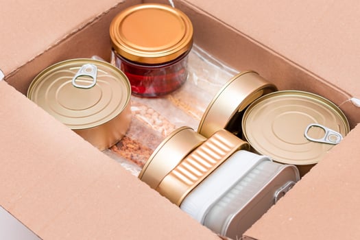 Food Reserves or Donation Box. Carton Box with Canned Food, Cereals and Grocery. Emergency Food Storage in Case of Crisis. Free Social Help, Blessings and Care. Strategic Food Supplies photo