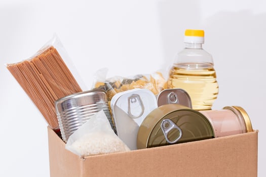 Donation Box of Free Food. Carton Box with Canned Food, Cereals and Grocery. Meal Reserves. Emergency Food Storage in Case of Crisis. Free Social Help, Blessings and Care. Strategic Food Supplies photo