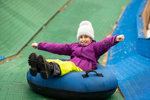 Children ride on tubing. Winter entertainment. Tubing. People roll on the slides. photo