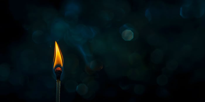 A Matchstick Burning in the Dark, Emitting a Glowing Flame photo