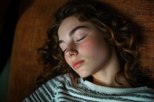 A young woman is sleeping on a couch photo