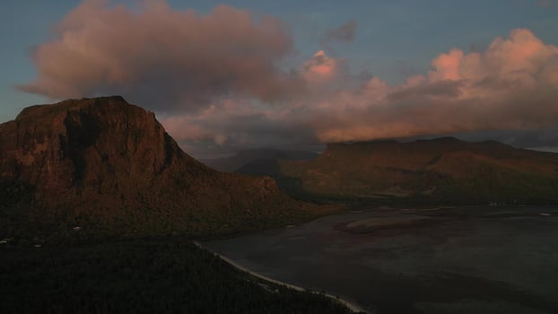Amazing sunset from the height of mount Le Morne Brabant and the waves of the Indian ocean in Mauritius .Underwater waterfall near mount Le Morne in the Indian ocean. photo